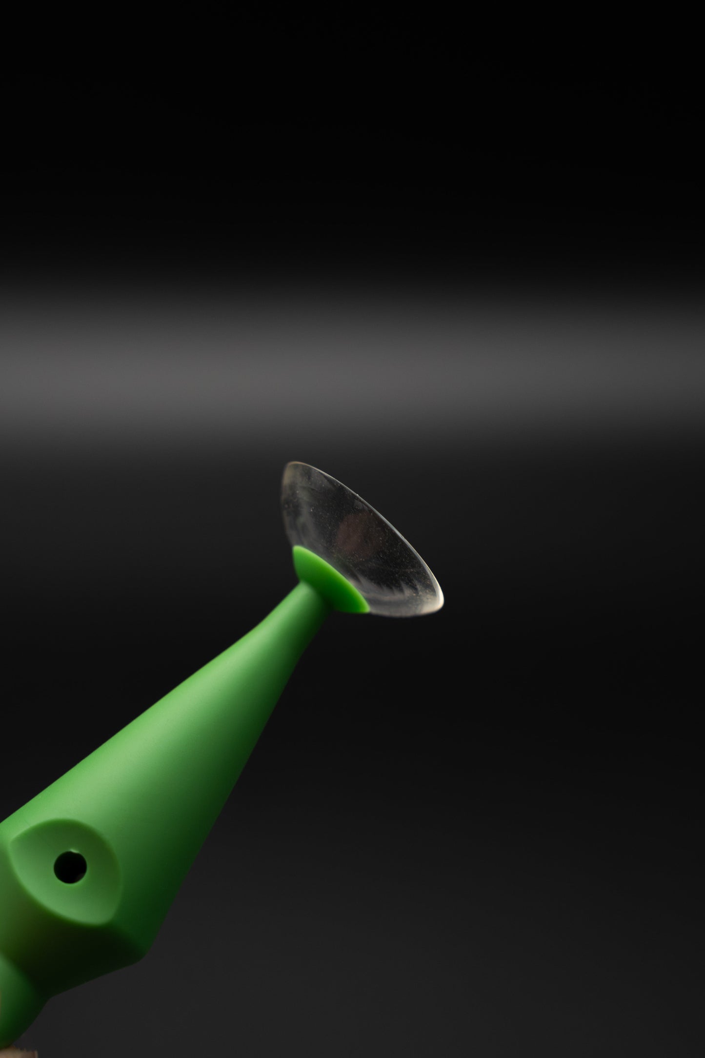 ScleralEase tool held in hand showing applicator end