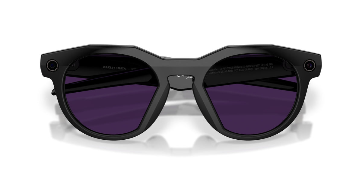 Oakley Meta HSTN Polished Black / Clear to Amethyst Transitions — lenses activated, three-quarter