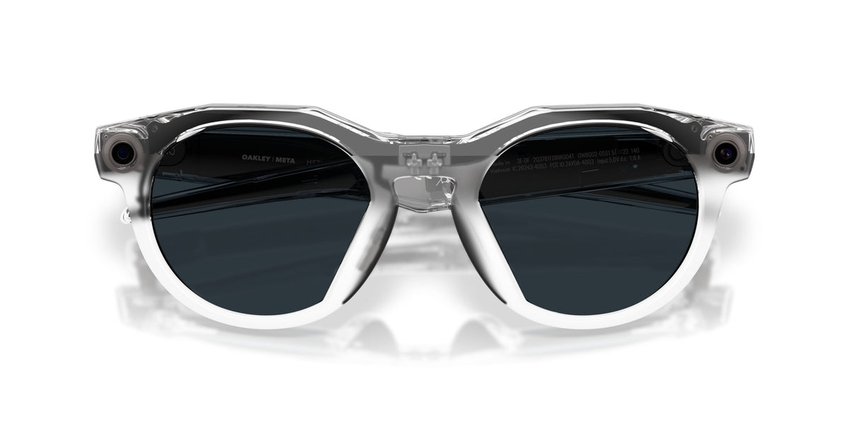 Oakley Meta HSTN Polished Clear / Clear to Grey Transitions — lenses activated, three-quarter